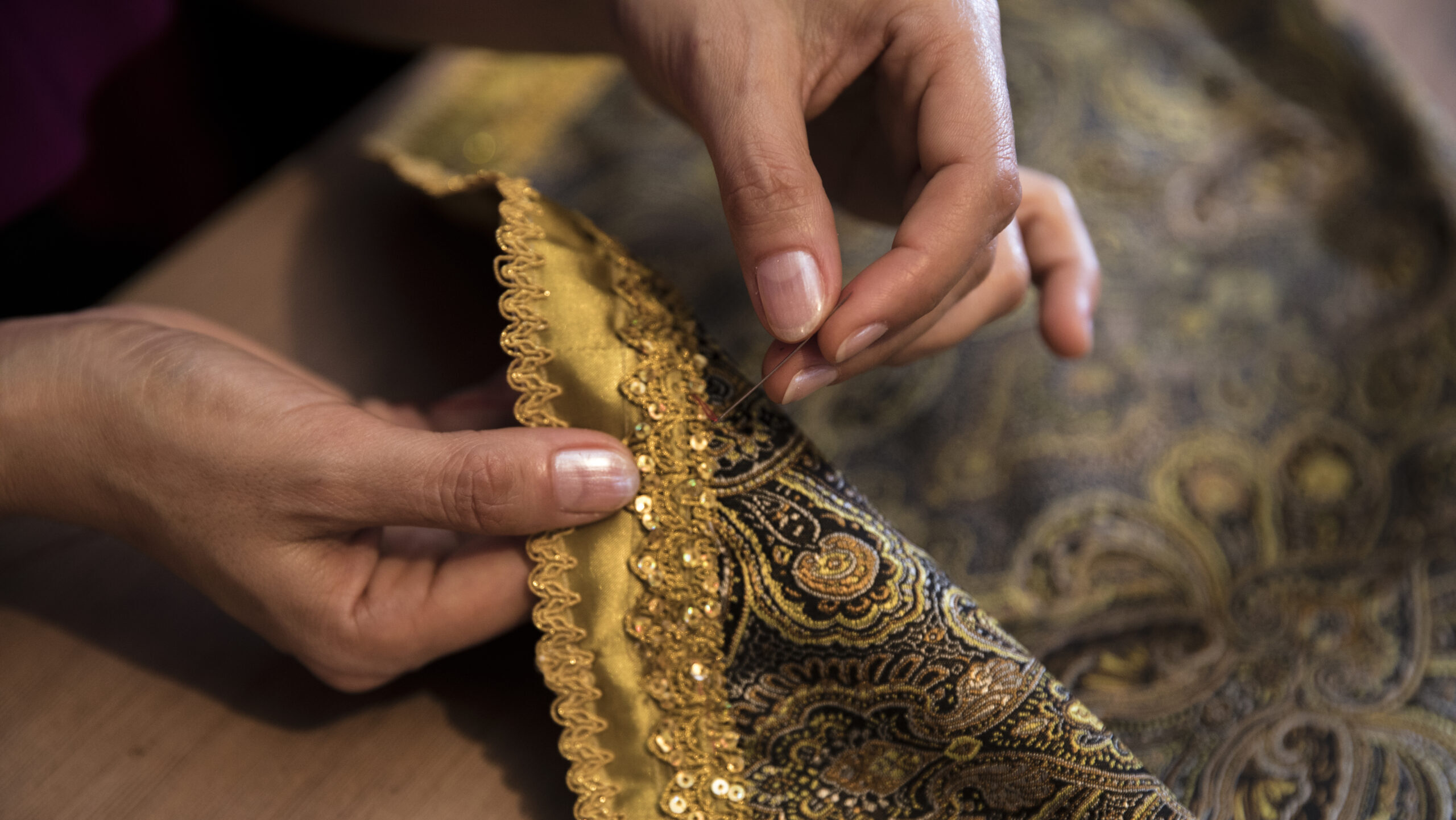 Knitting golden ribbon to the carpet. High quality photo